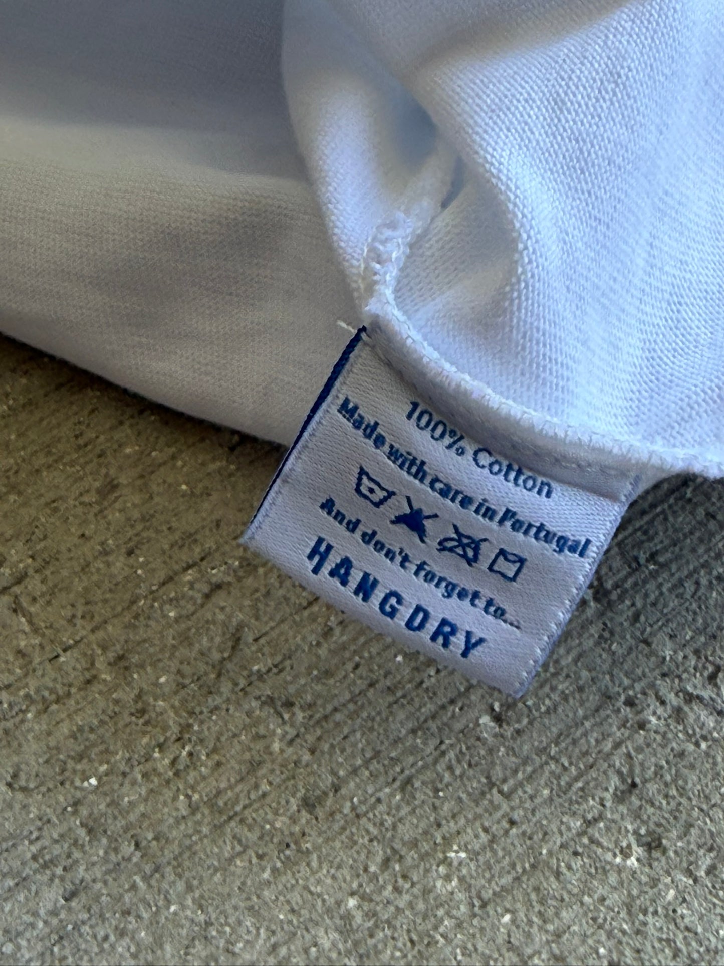 Hang Dry tee garment care label — detailed wash instructions on the Gallery White Sunday Dinner tee