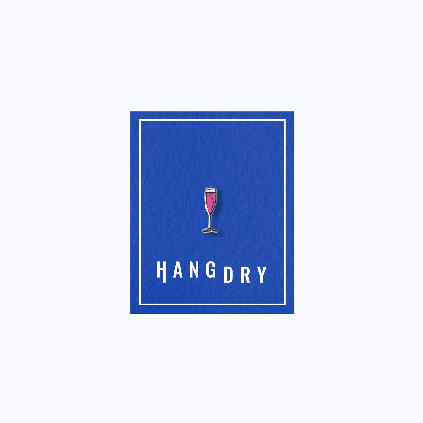Hang Dry Sunday Dinner enamel pin — champagne flute shape, displayed on Hang Dry blue branded card