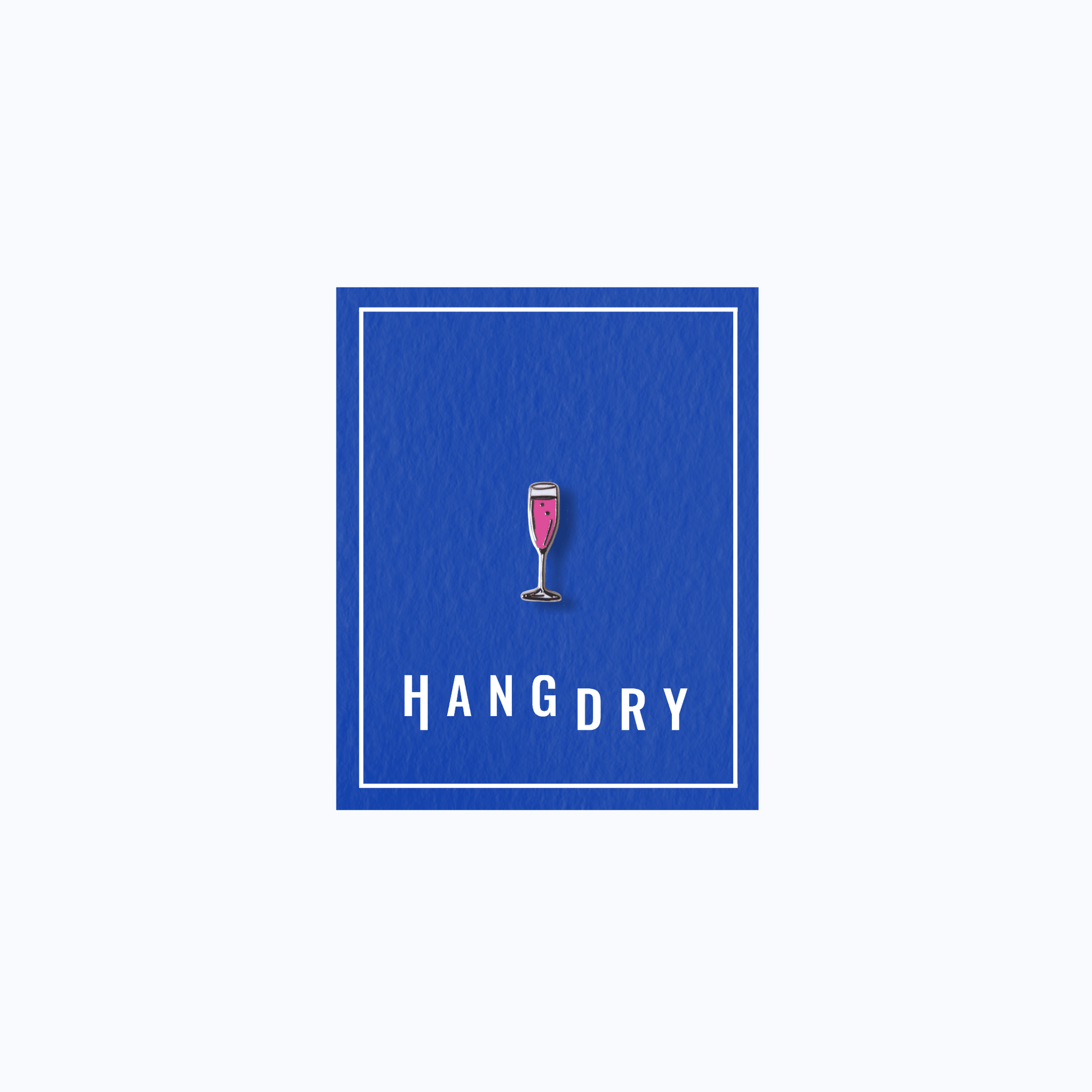 Hang Dry Sunday Dinner enamel pin — champagne flute shape, displayed on Hang Dry blue branded card
