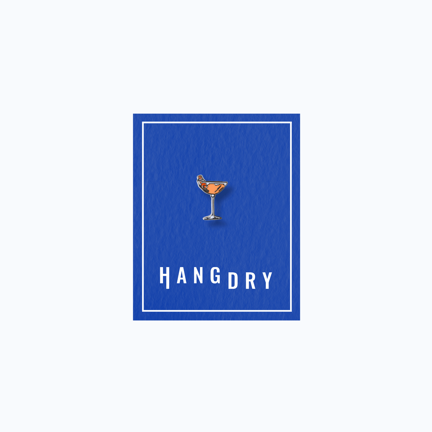Hang Dry Sunday Dinner enamel pin — coupe glass shape, displayed on Hang Dry blue branded card