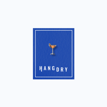 Hang Dry Sunday Dinner enamel pin — coupe glass shape, displayed on Hang Dry blue branded card
