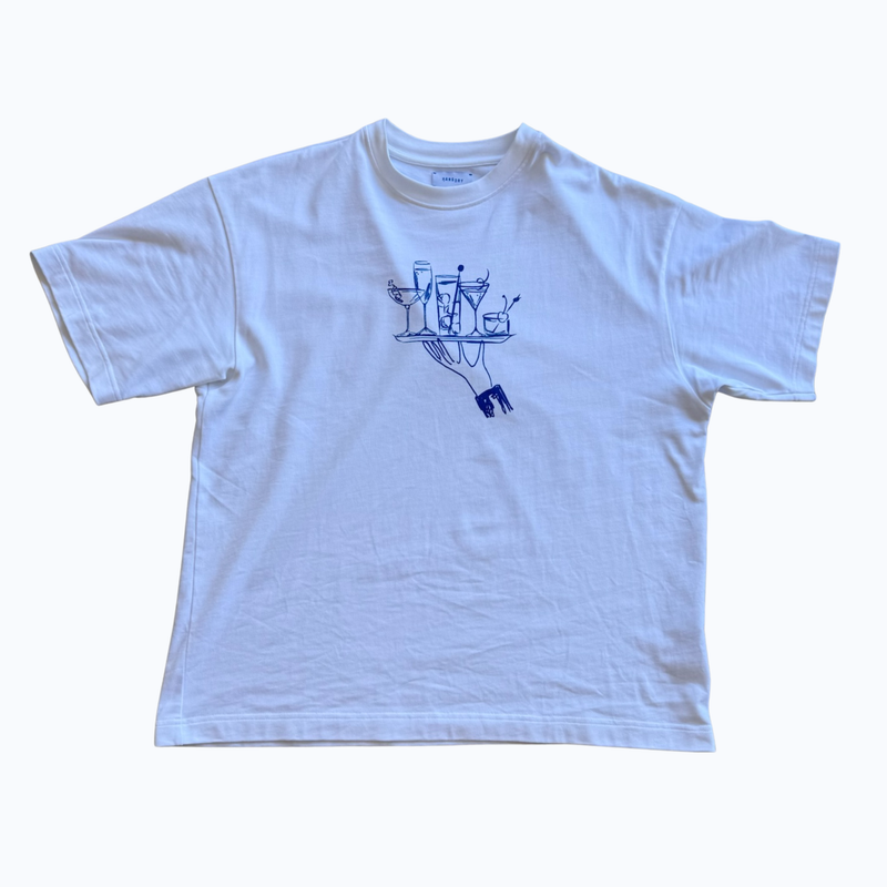 Hang Dry Gallery White Sunday Dinner tee — flat lay product photo on concrete showing the hand and cocktail tray illustration
