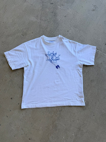 Hang Dry Gallery White Sunday Dinner tee flat lay — overhead product shot on concrete showing full graphic