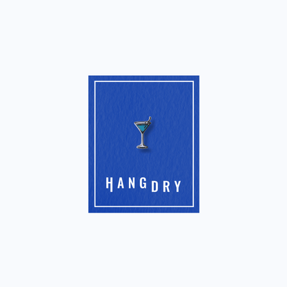 Hang Dry Sunday Dinner enamel pin — classic martini glass shape, displayed on Hang Dry blue branded card