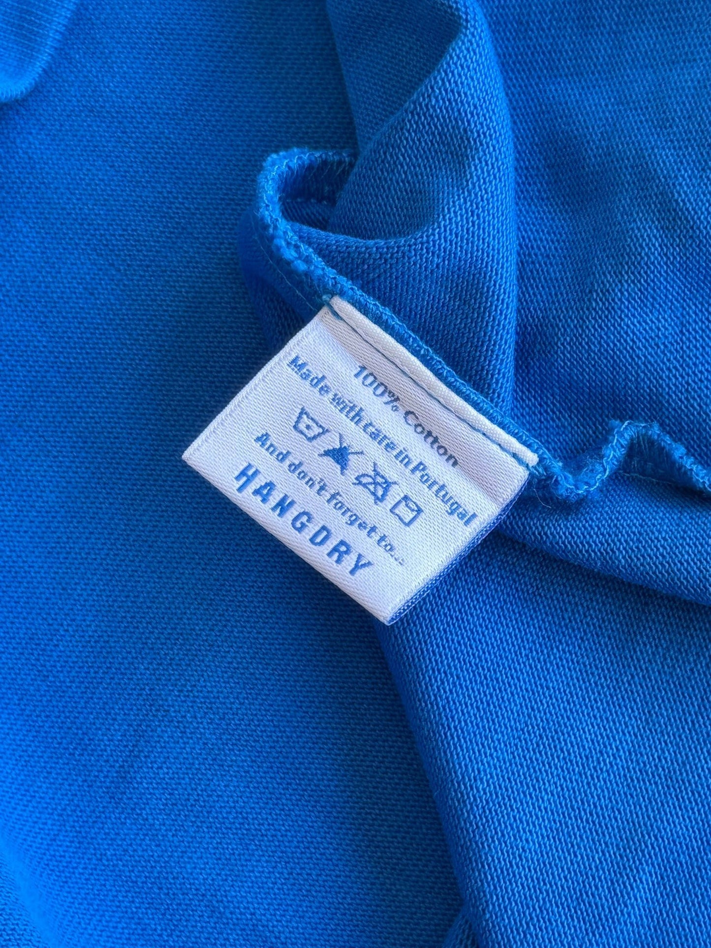 Hang Dry Studio Blue tee garment care label — wash and care instructions for longevity