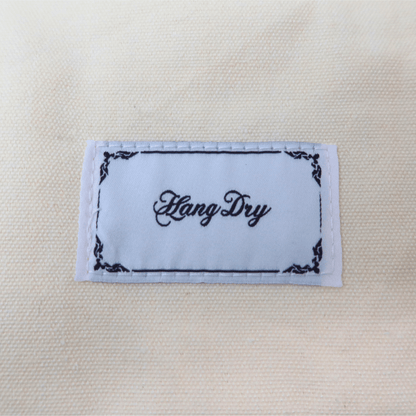 Hang Dry brand tag attached to the Sunday Dinner white tote bag